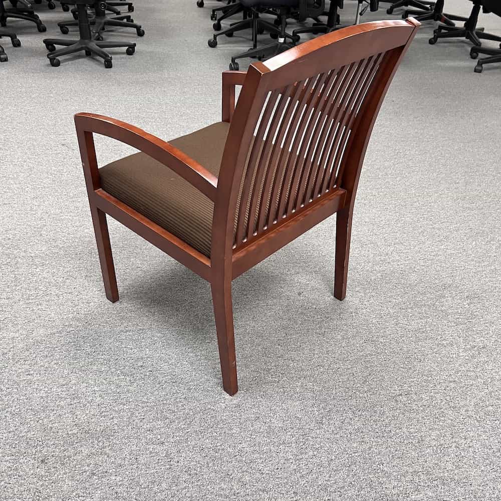 brown and black striped upholstery, and cherry veneer frame with ventilation vertical slates on the back, back view