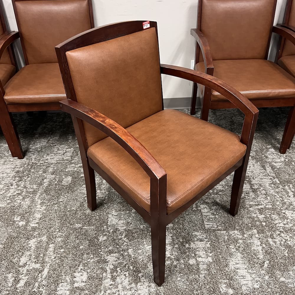 brown vinyl guest chair with walnut arms, used office furniture