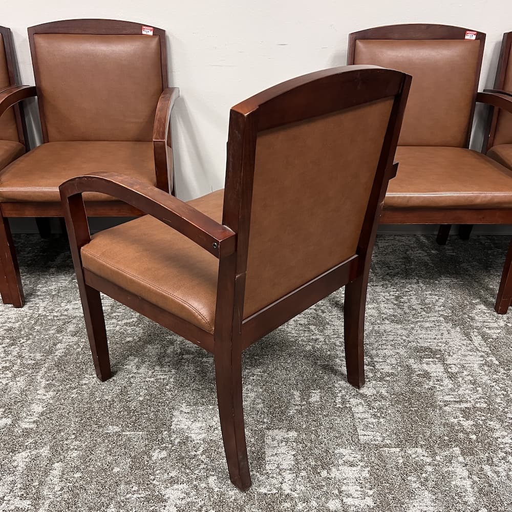 brown vinyl guest chair with walnut arms, used office furniture
