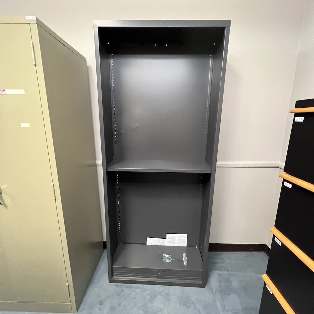 dark grey metal bookcase, shelves all stacked at the bottom