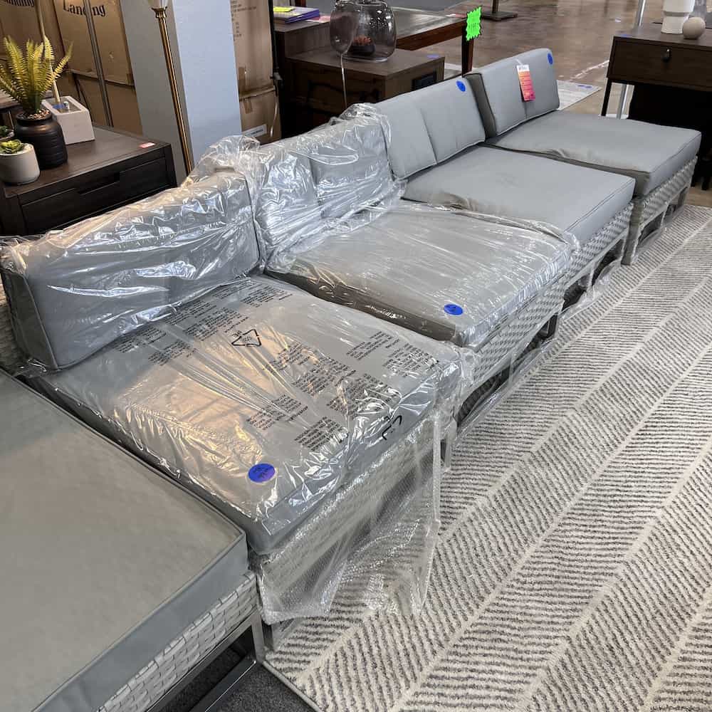 grey rectangle outdoor lounge furniture, close to the floor with a short and long back pillow, in a row