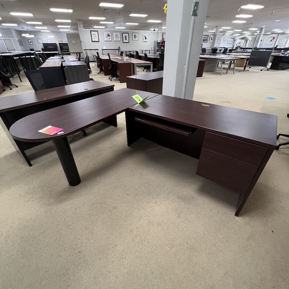 mahogany l-desk with return on the right, bullet nose rounded main desk, return has a keyboard drawer