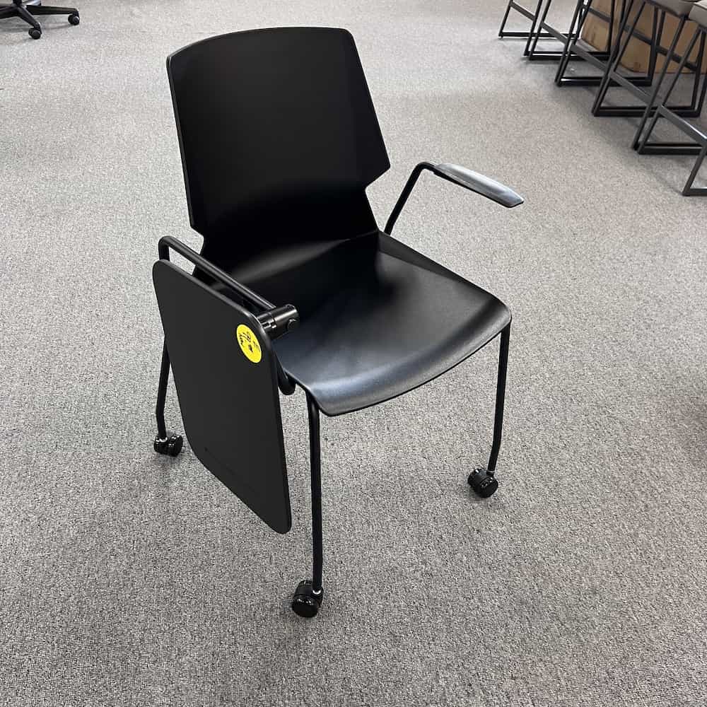 black plastic and metal table chair, table swiveled down to the left side