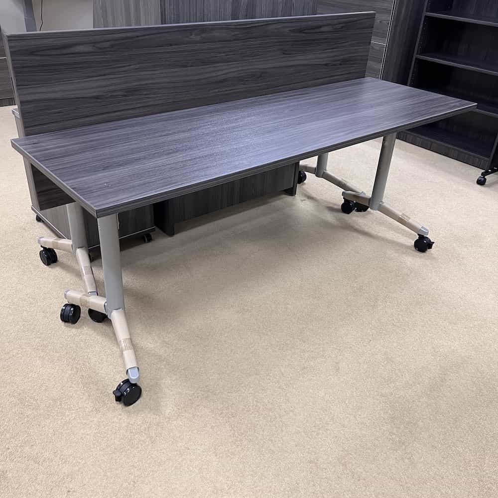 grey training table, new, with light grey silver legs and black wheels