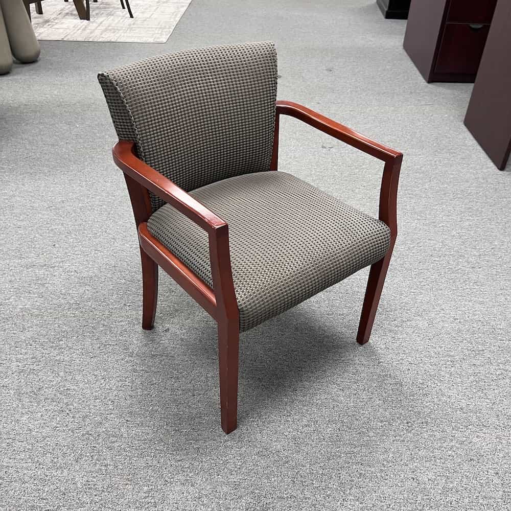 teal and taupe patterned upholstered guest chairs with cherry veneer arms