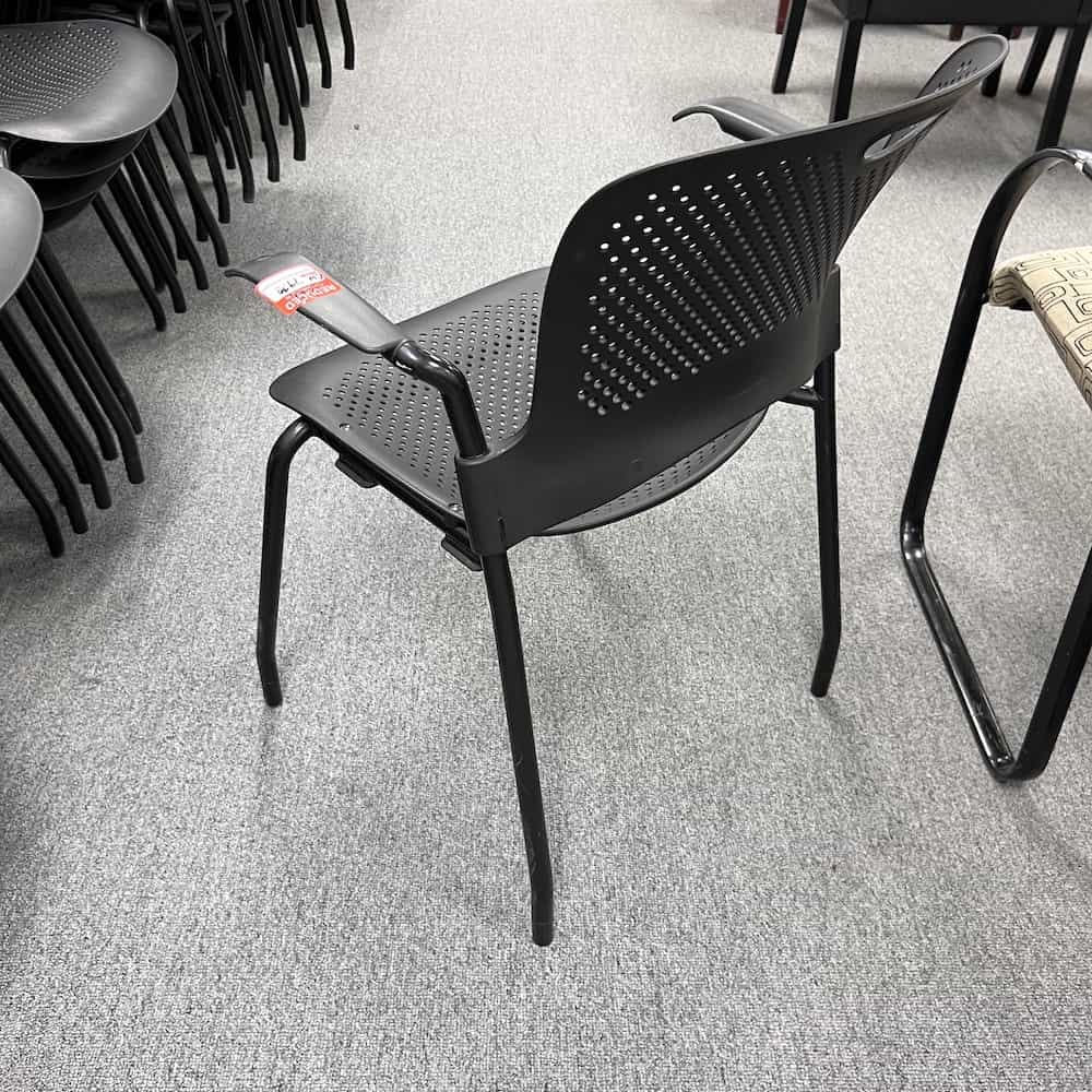 black caper herman miller stacking chair with arms, back view
