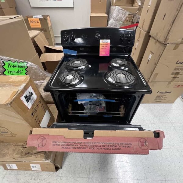 black ge stove, electric, with cardboard and packing still attached, door open