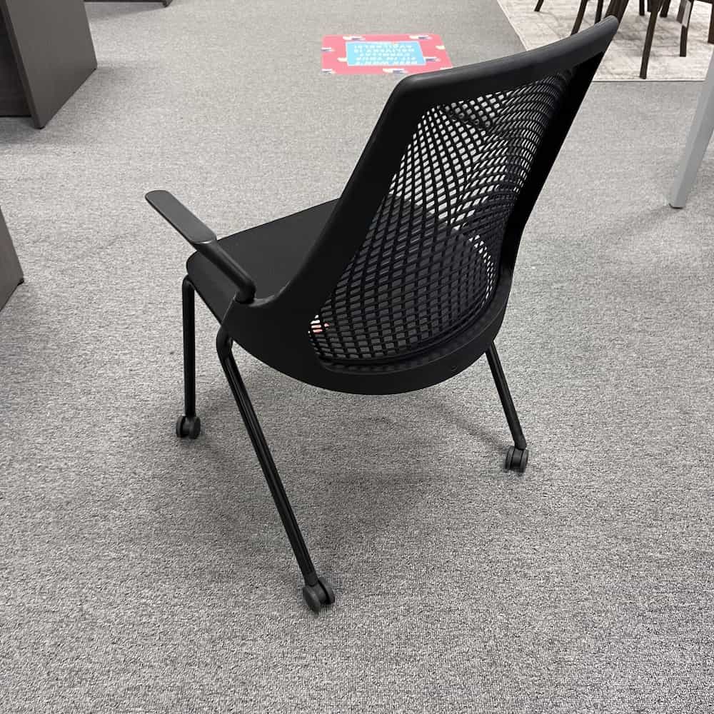 black seat and elastometer back sayl rolling chair with arms, back view