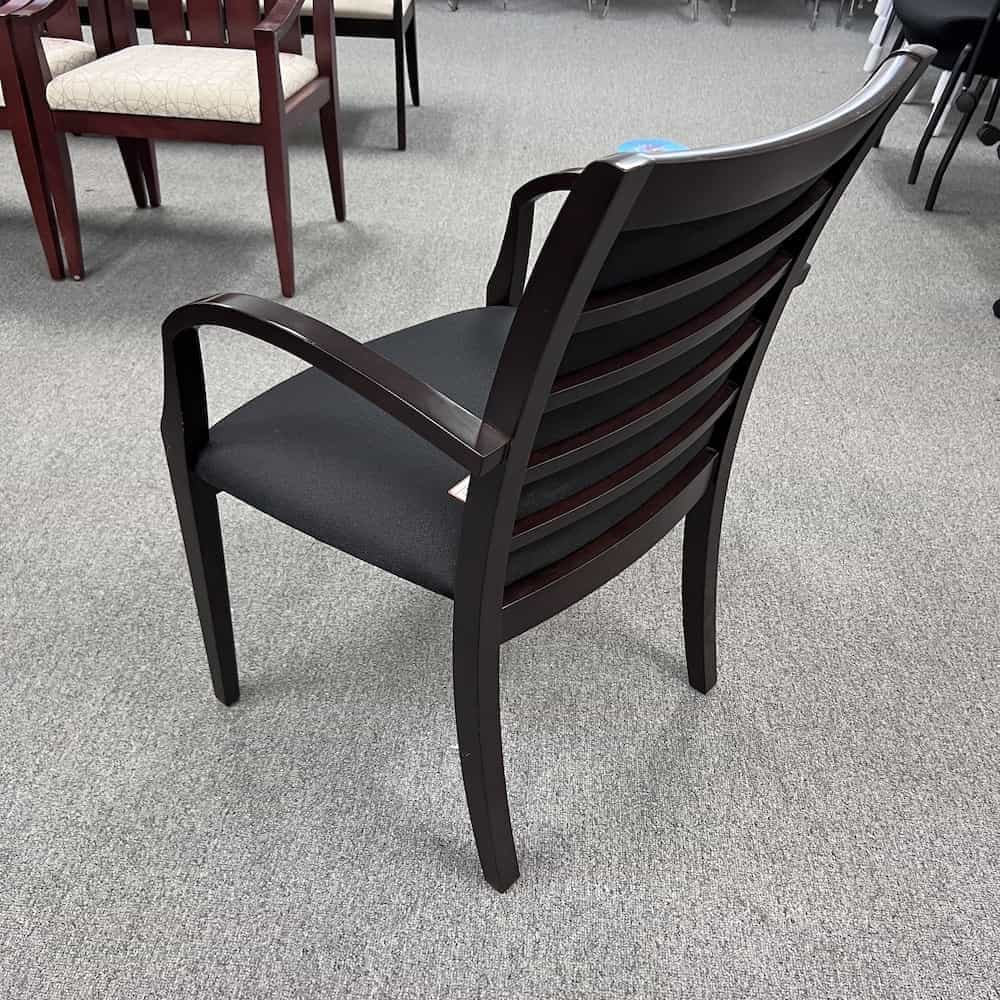 espresso glossy veneer frame and arms guest chair with black upholstered seat and back used, ladder back