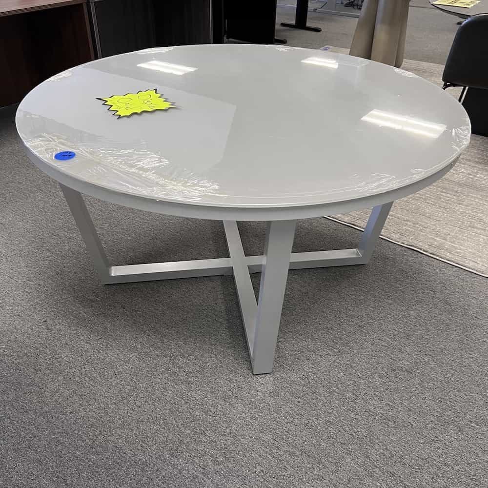 grey round glass topped dining table for the patio