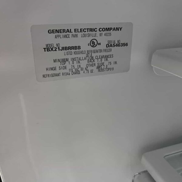 black ge refrigerator with freezer top, model number and info