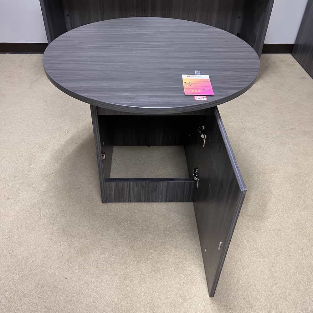 grey laminate round break room table with cupboard base, open on the bottom