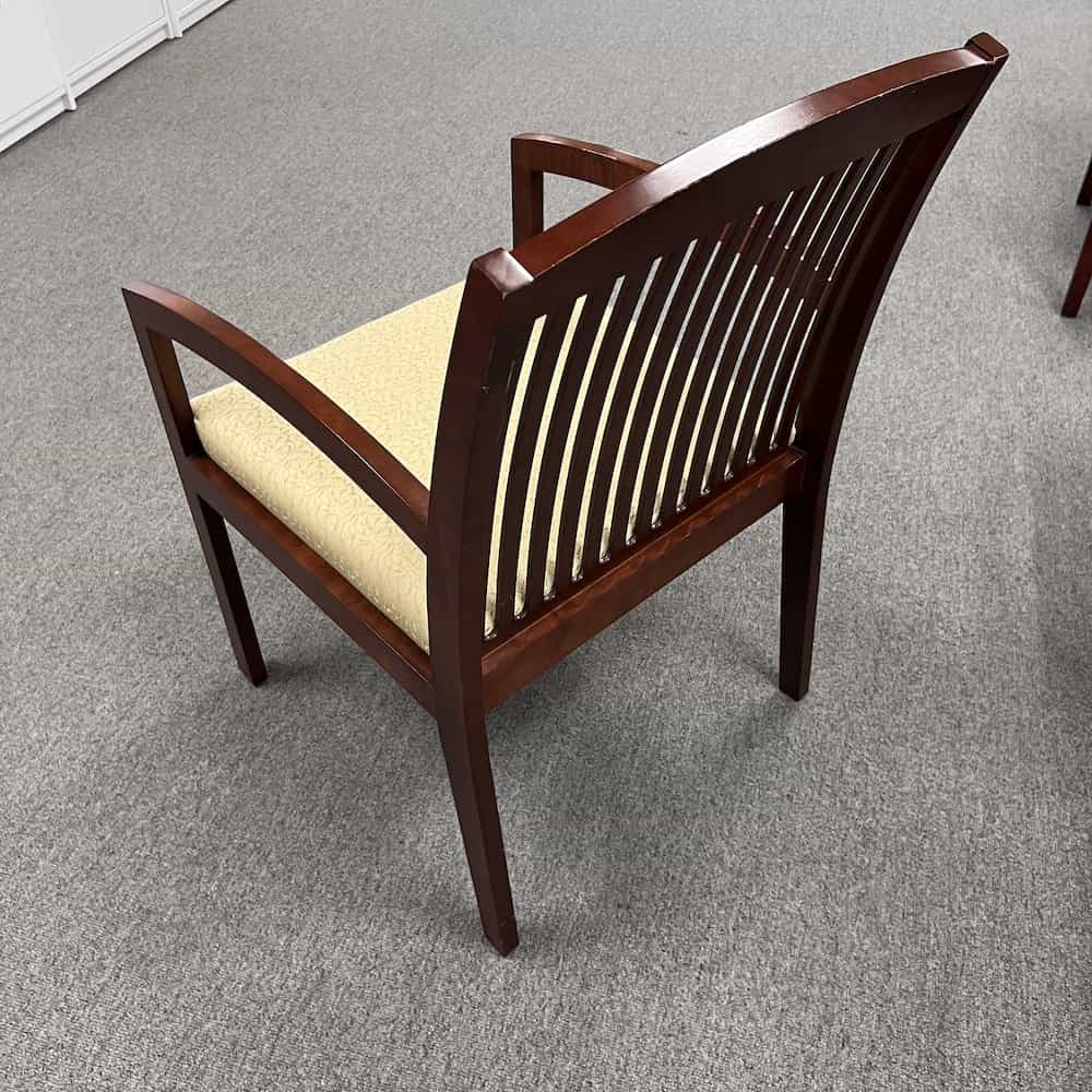 Beige upholstery and mahogany veneer wood frame chair, back view
