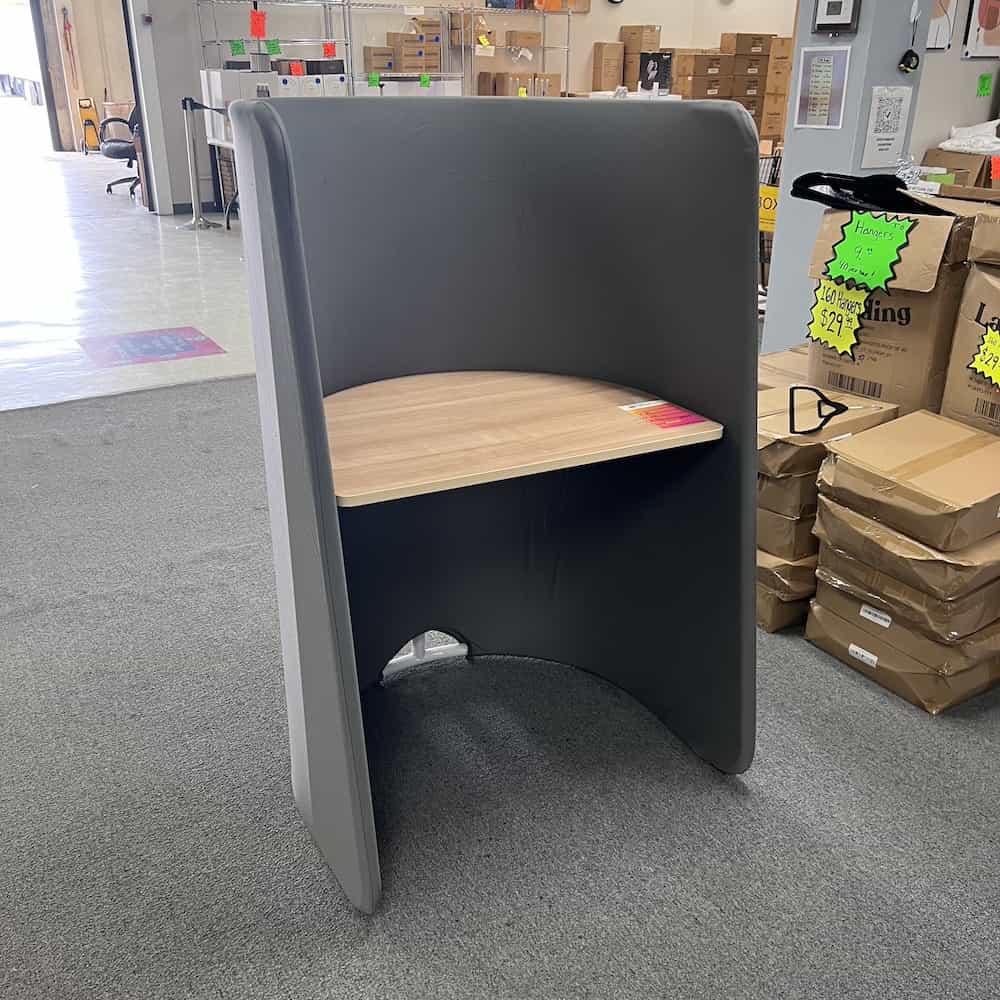 grey fabric sides, maple laminate desk area, there is a metal white frame underneath, rounded high sides, horseshoe shape