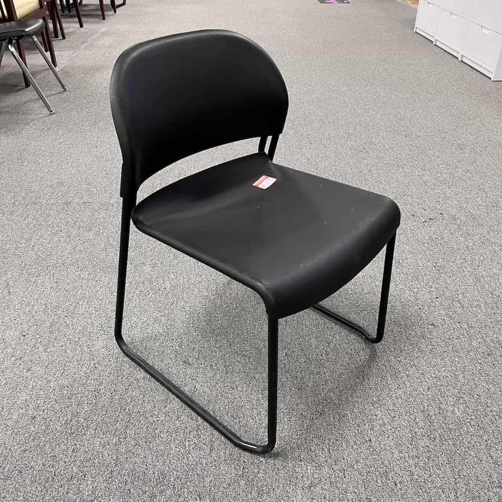 black plastic stacking chair with rounded back, hon brand