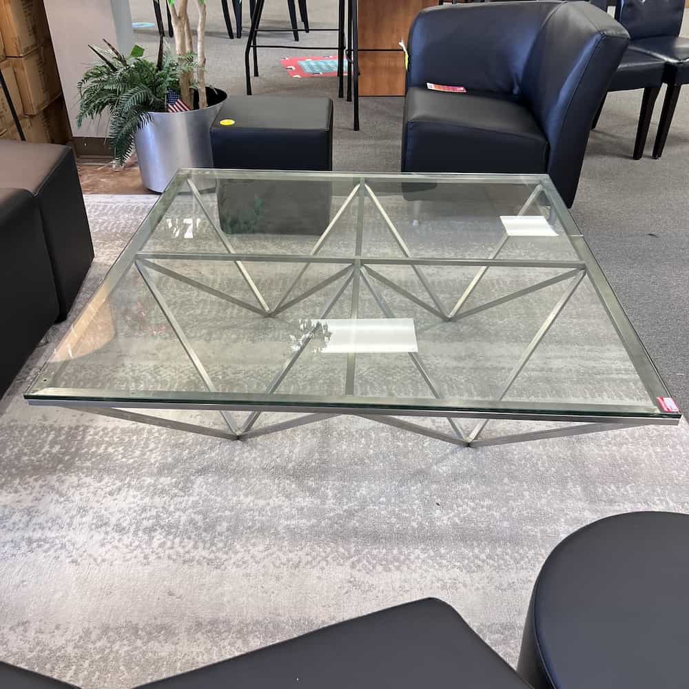 glass square table with silver triangle base, modern