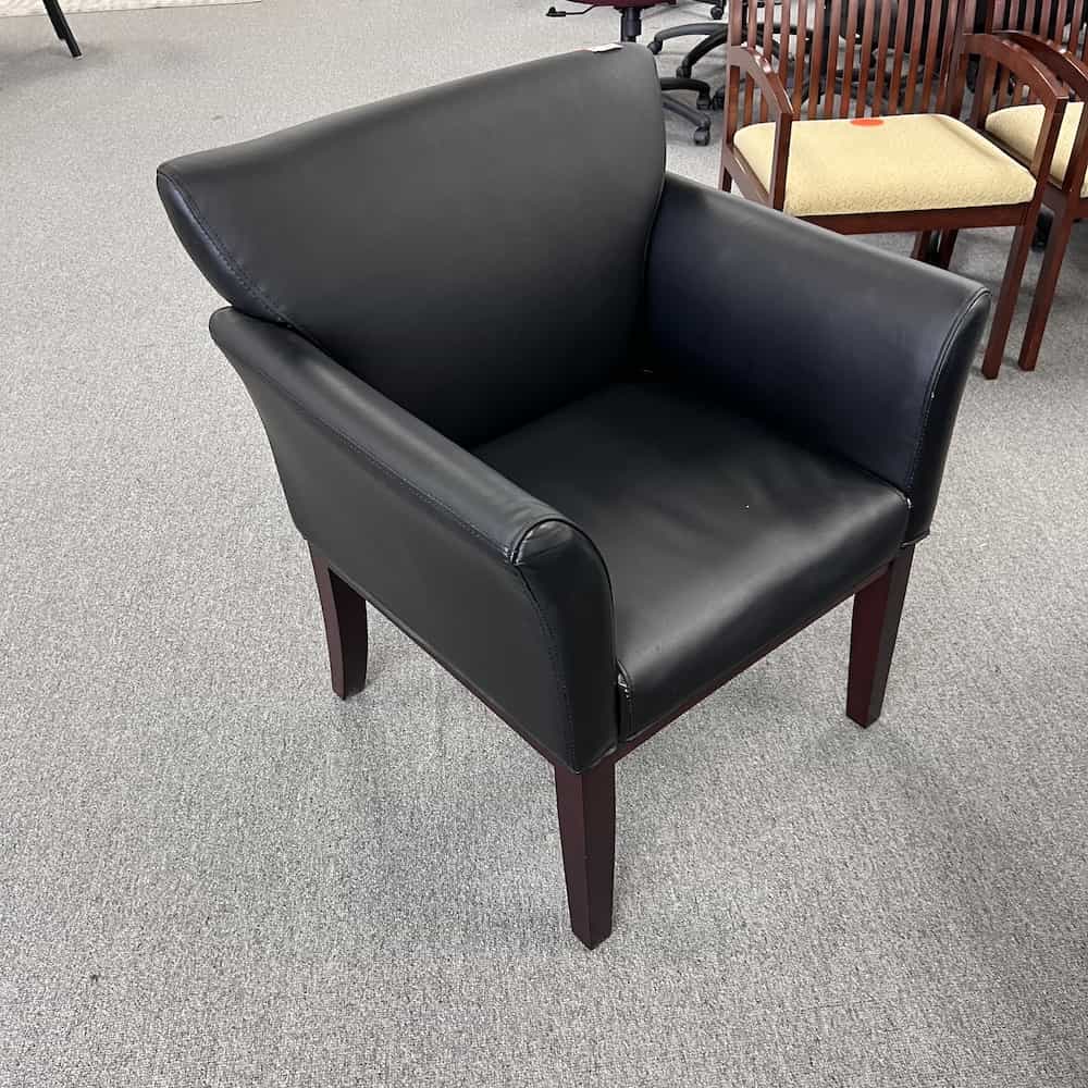 black vinyl guest chair with arms and mahogany legs