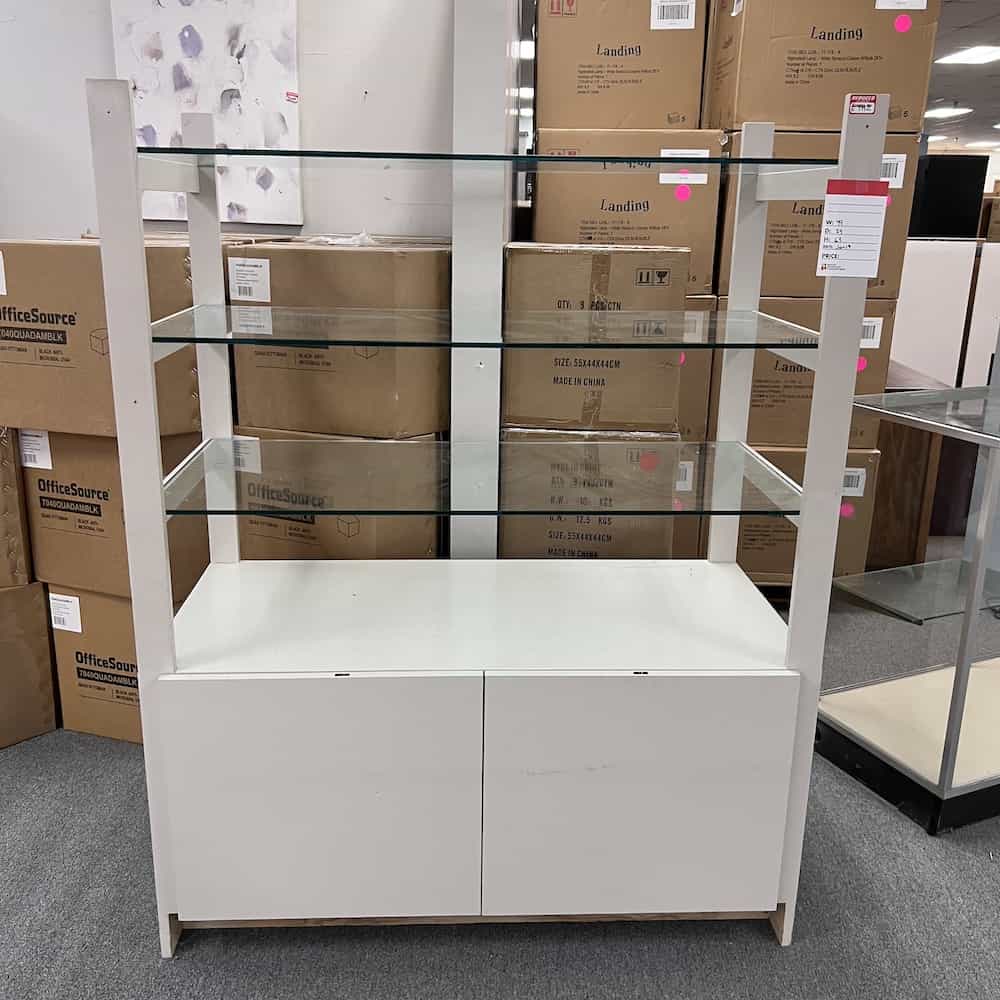 glass shelf display case with white drawers on base