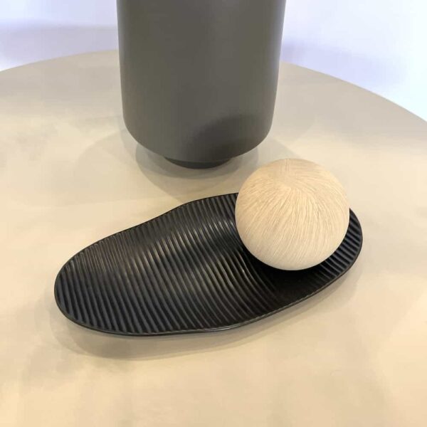 grey ceramic vase, dark grey plate and taupe ceramic ball