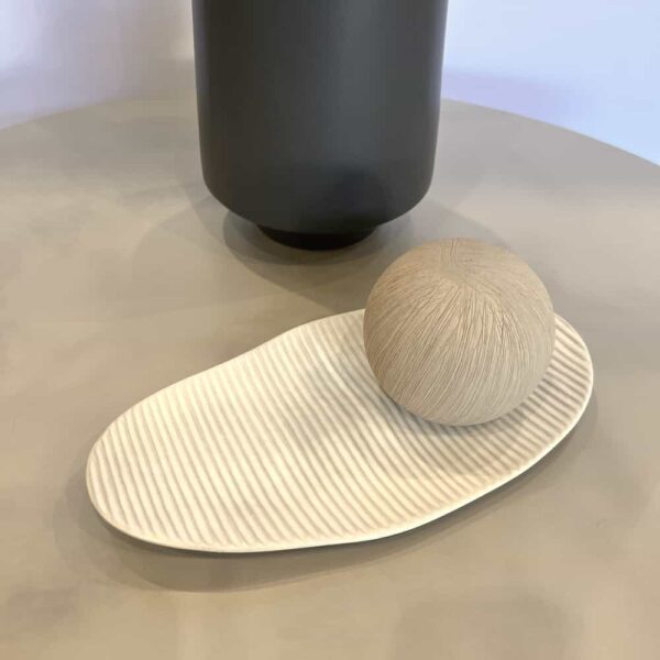 white plate and taupe ceramic ball