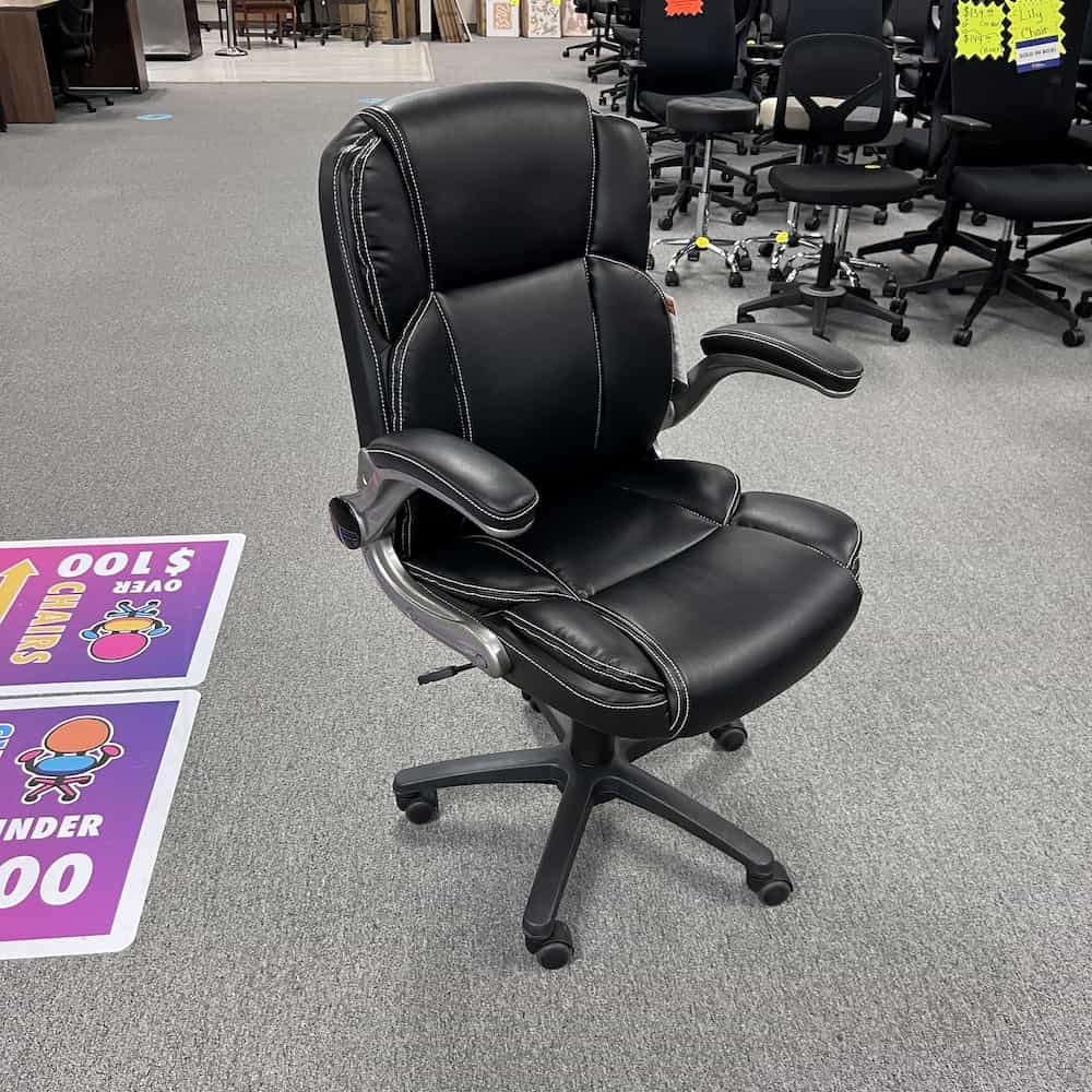 black vinyl plush executive chair with flip up arms