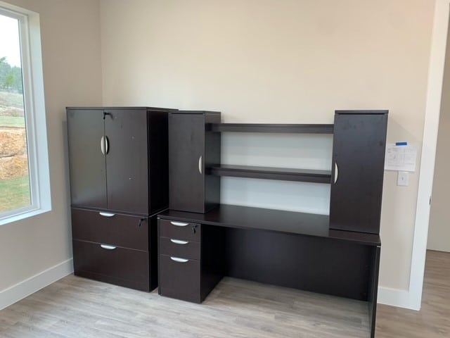 a photo showing brand new office furniture just installed, espresso credenza with hutch and storage cabinet