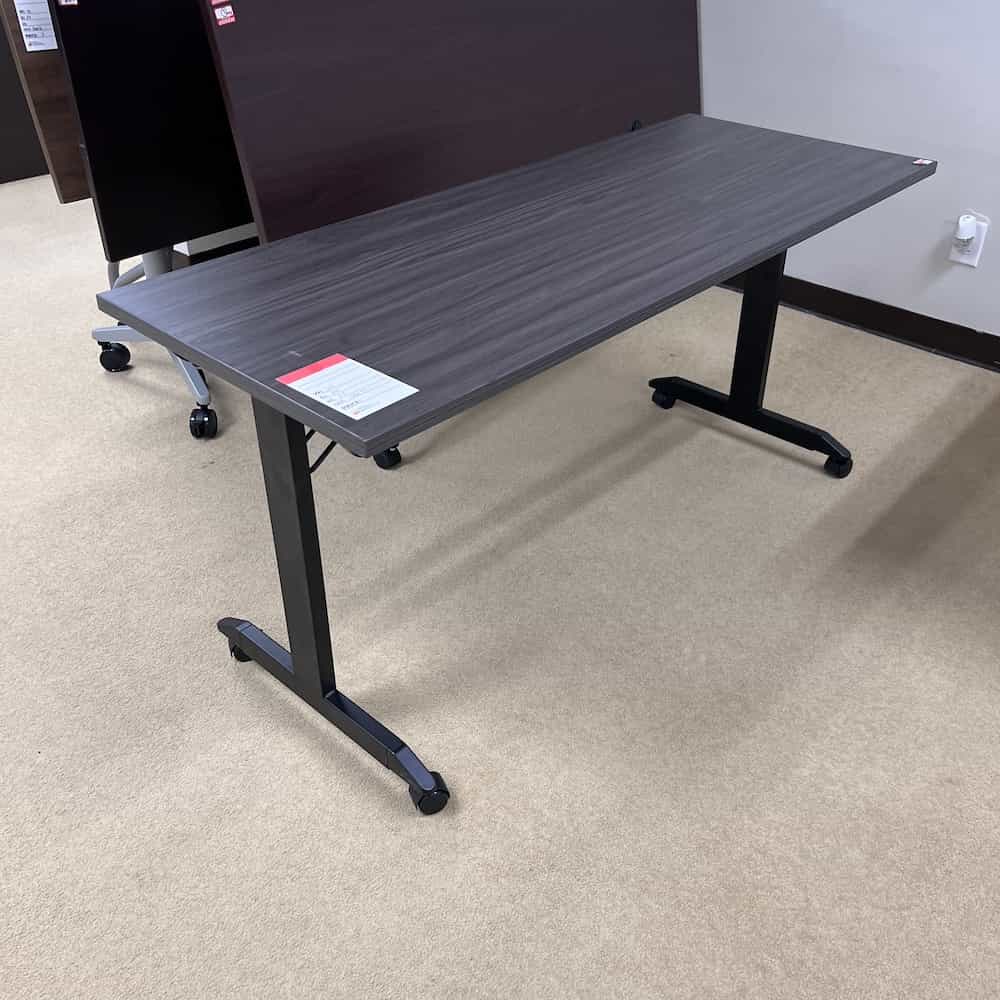 grey rectangle table with black legs and wheels