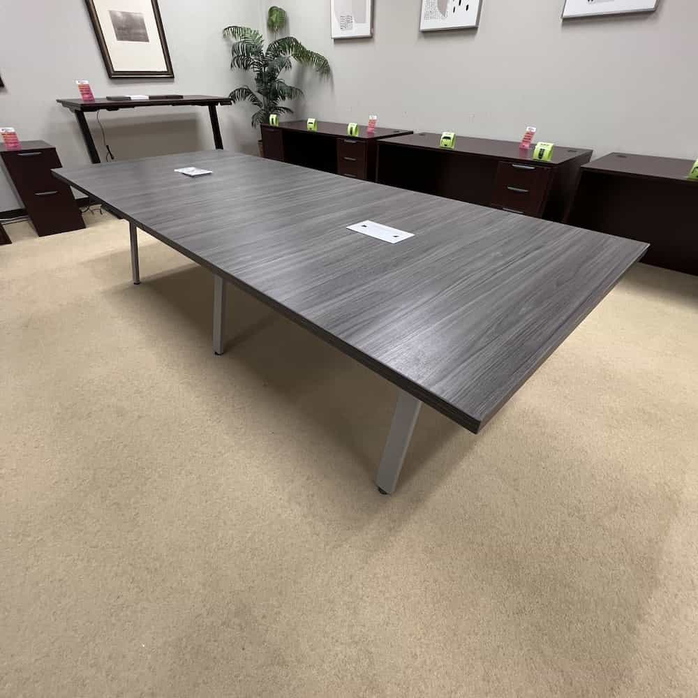 grey rectangle conference table with angled silver legs, 3 sets of legs, silver chord port holes