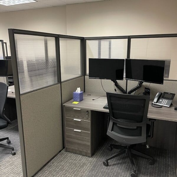 a photo showing brand new office furniture just installed, a photo showing brand new office furniture just installed, grey desks with paneling, monitor arms