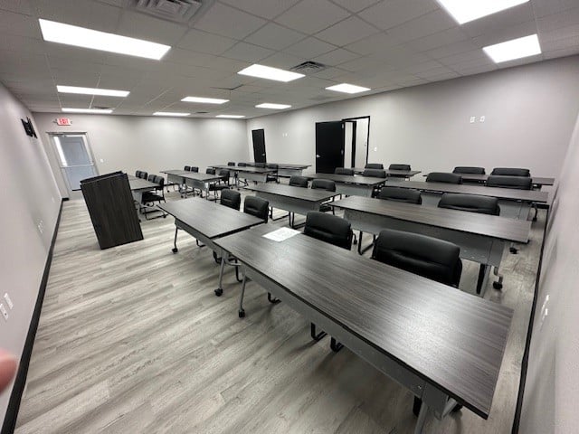 a photo showing brand new office furniture just installed, training tables and chairs and a podium