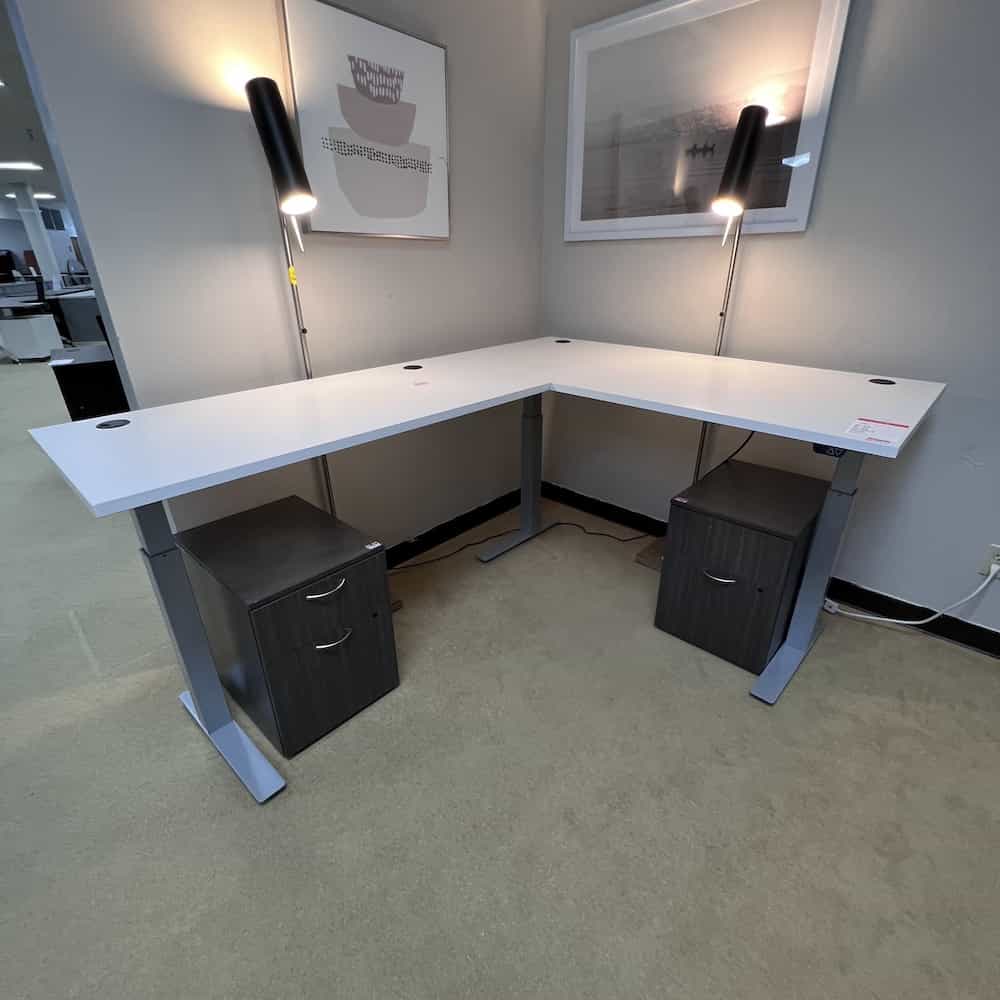 white height adjustable l-desk with grey metal legs