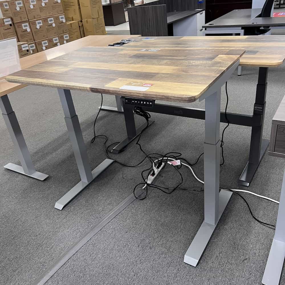 a new woodgrain laminate vari desk top with a grey metal knoll used base
