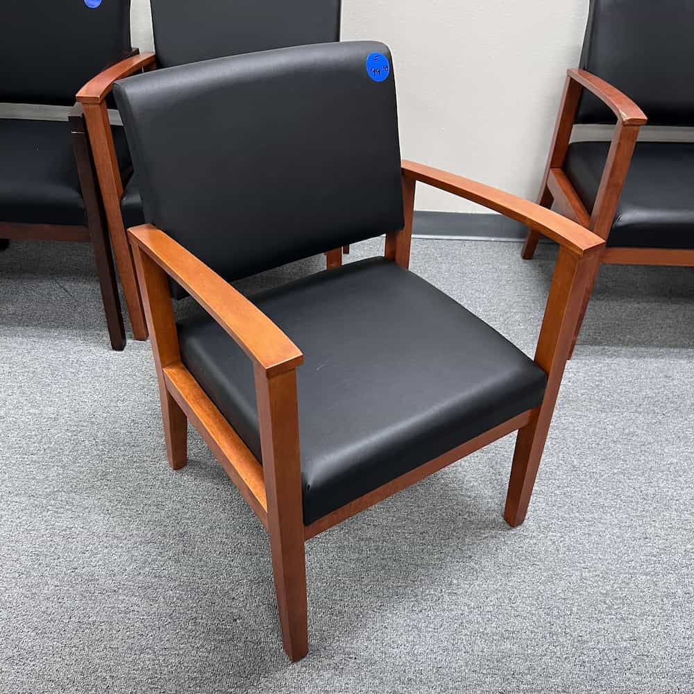 cherry arms and frame veneer, black vinyl seat and back guest chair