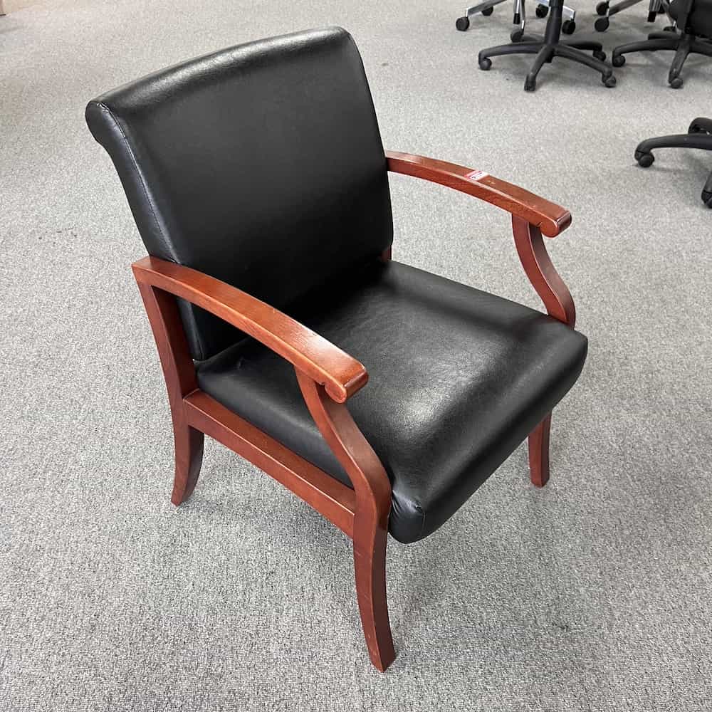 black vinyl guest chair with cherry veneer arms and legs