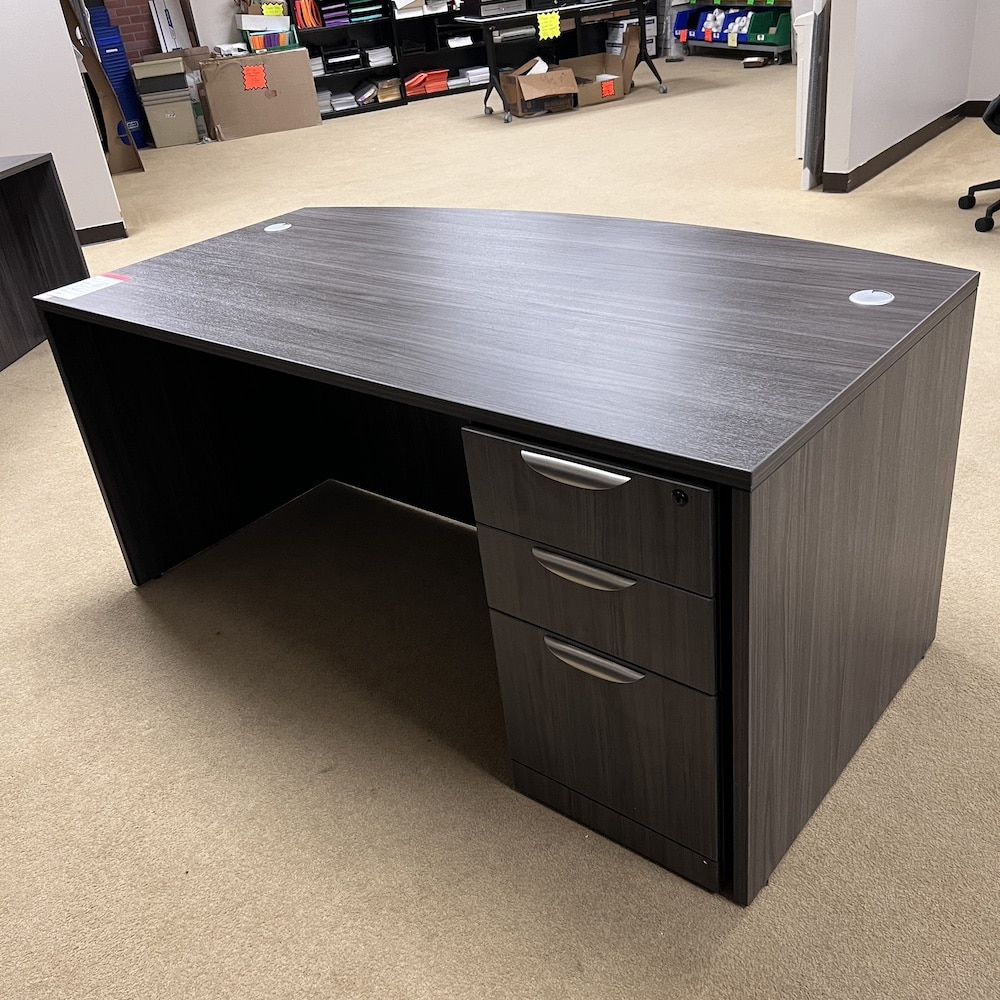 grey laminate bow front desk with file file on the right side