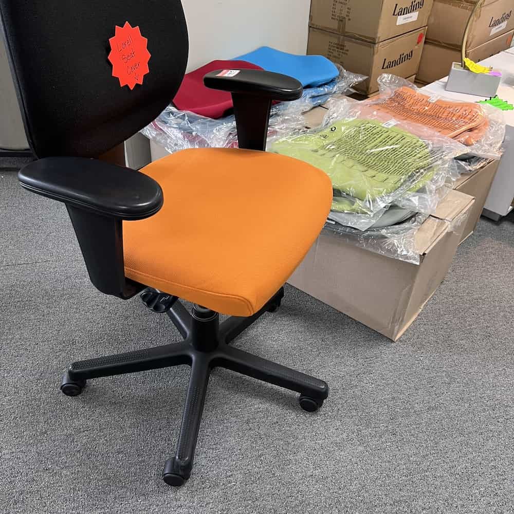 seat covers in orange, green red and blue, shown on a black chair in orange