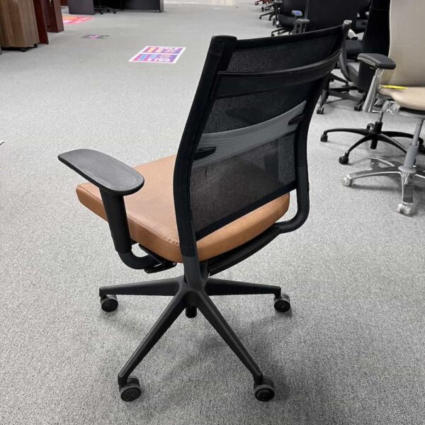 sitonit wit chair with black mesh back and tan vinyl seat
