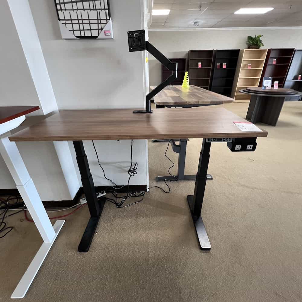 walnut laminate height adjustable desk with black base and single monitor arm