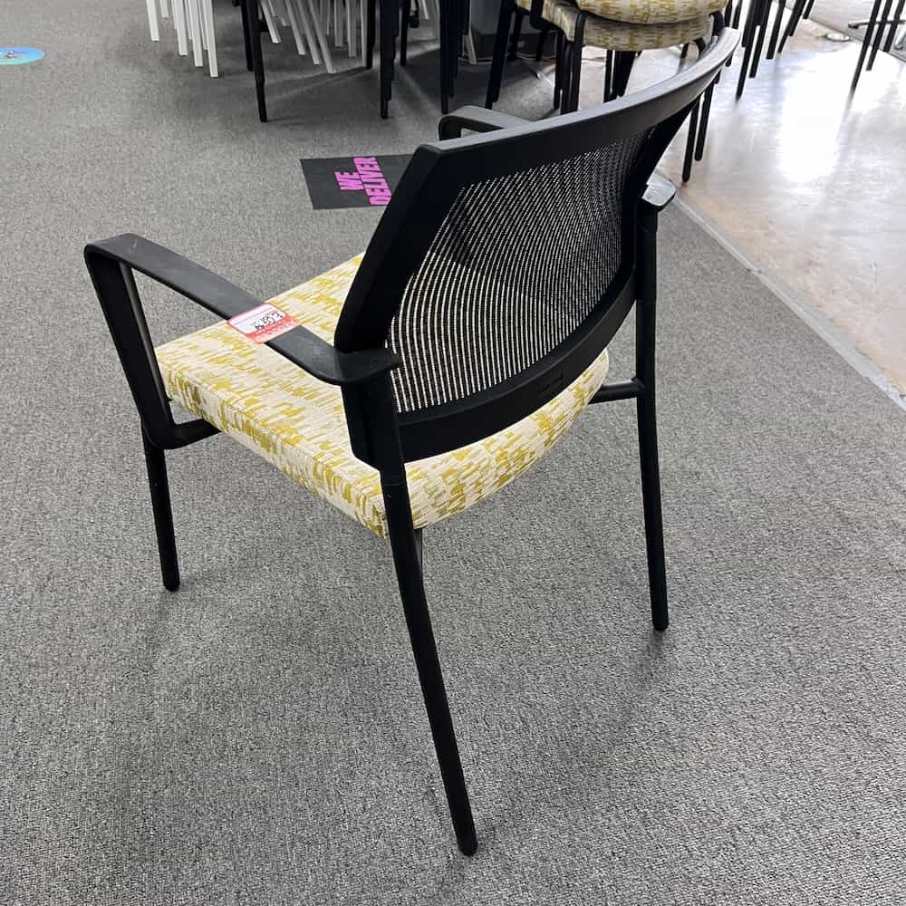 yellow stacking chair with black mesh back sitonit
