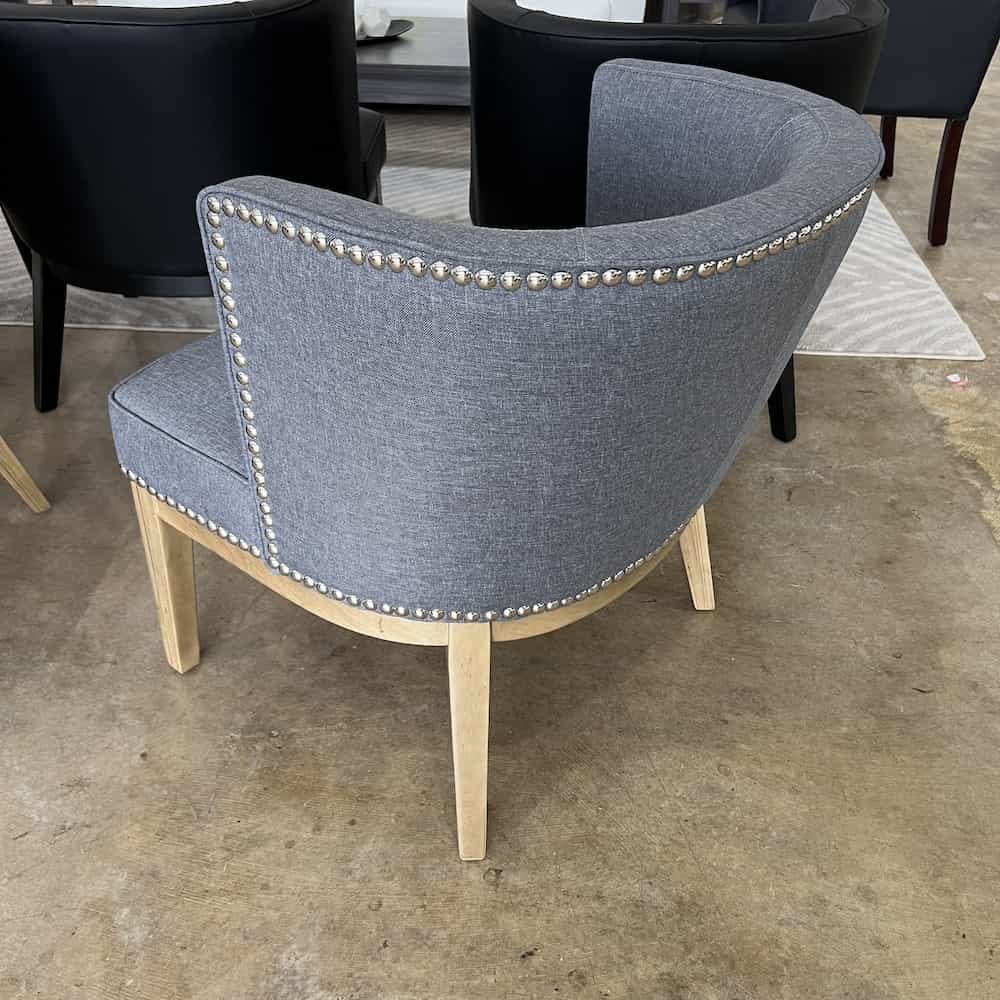 new grey upholstered cocktail chair mid back with silver nail heads and walnut veneer legs