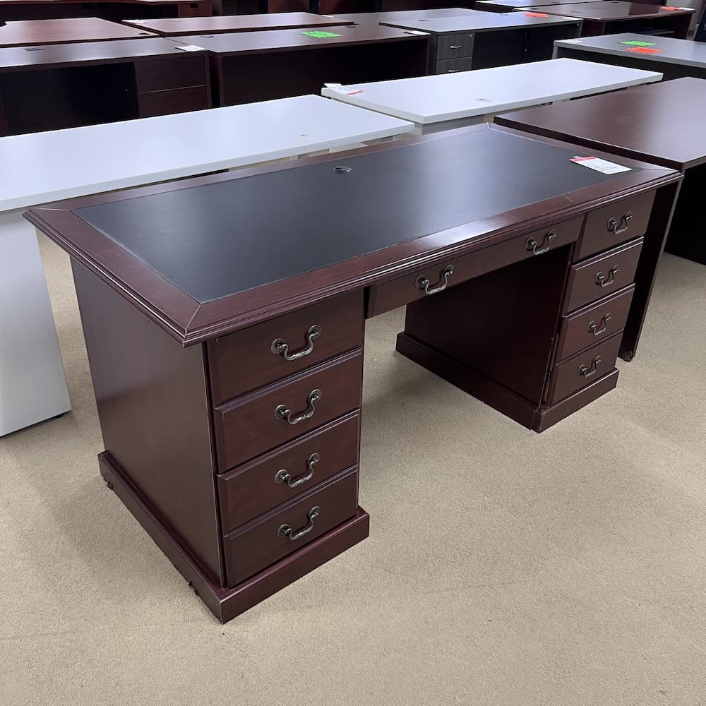 mahogany traditional desk, sander, with black blotter center and double pedestal. Used office furniture