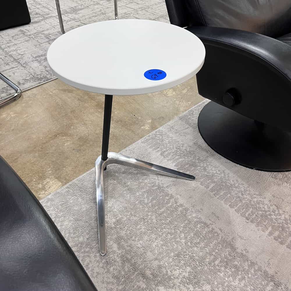 white laminate round side table with black post and silver boomerang base