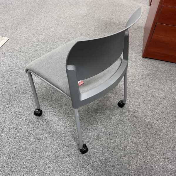 grey plastic back with grey upholstery seat, silver legs and rolling wheels, stacking steelcase move chair used