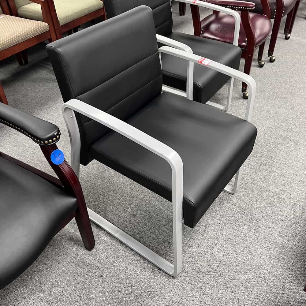 black vinyl guest chair with grey metal legs