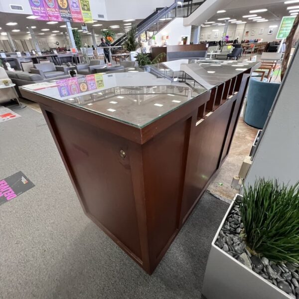 cherry veneer wood bar island with glass top and trash and storage