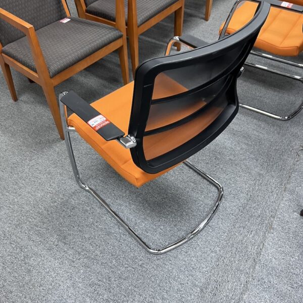 orange seat upholstered black mesh back and chrome legs used office furniture