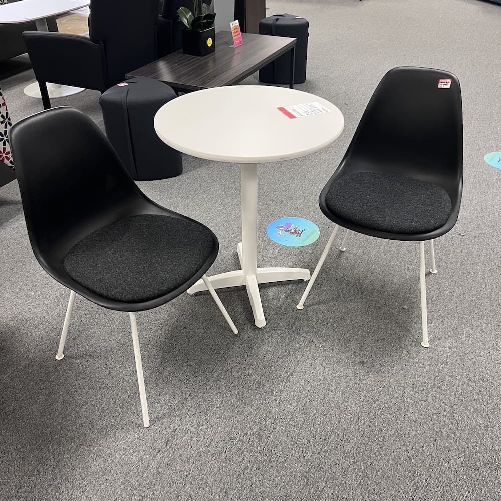 black plastic seat with white metal legs Herman Miller Eames chairs used furniture designer