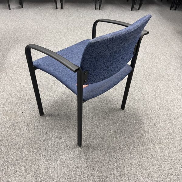 blue upholstered stacking chair with black frame, used office furniture