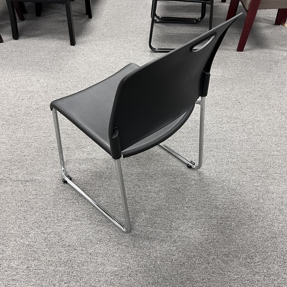 black plastic stacking chair with chrome legs, used office furniture