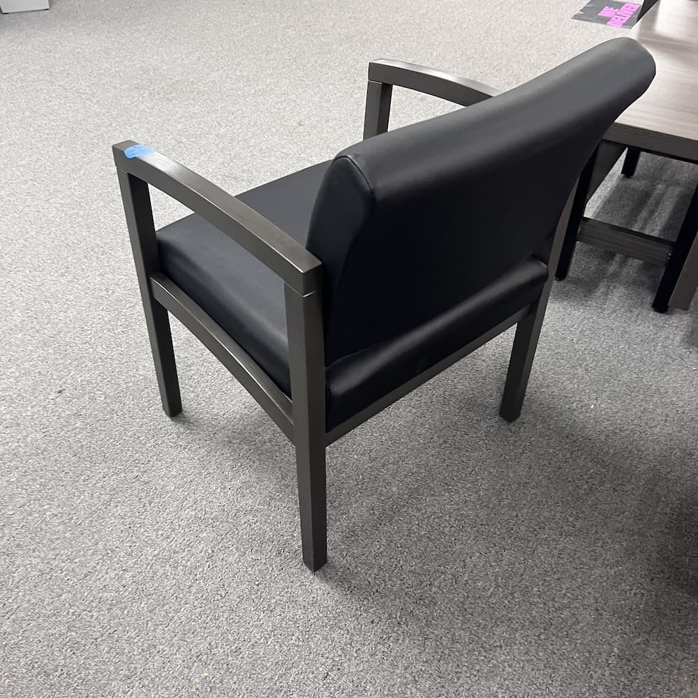 black vinyl guest chair with grey veneer arms and legs